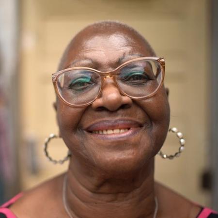 Woman wearing glasses with a soft smile – Pfizer Clinical Trials